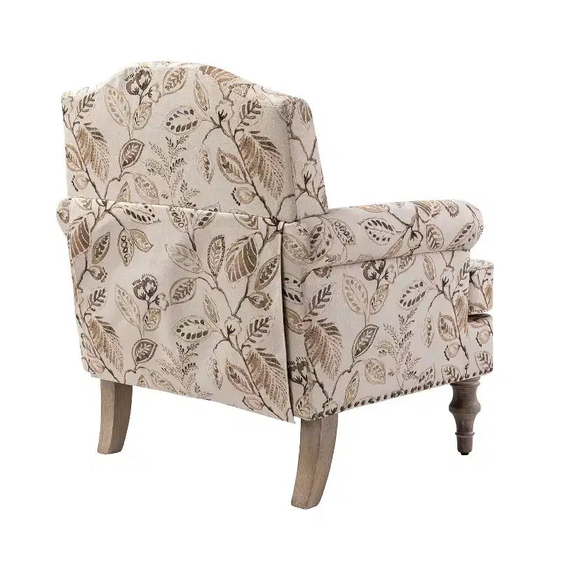 Fauteuil rembourré en bois avec motif floral, accoudoirs à panneaux et dossier en forme de bosse de chameau.